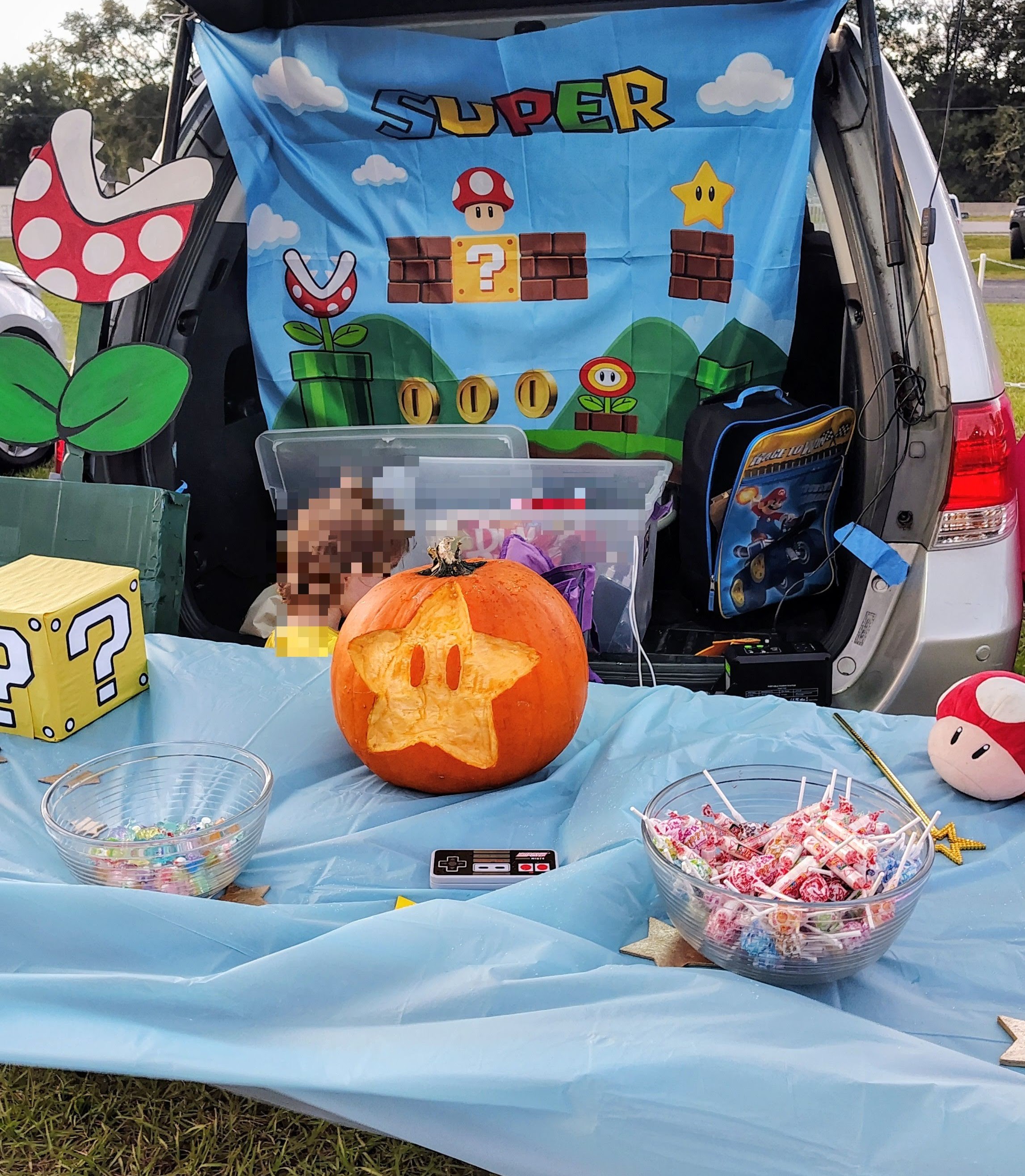 mario themed trunk or treat with super star jack o lantern pumpkin, question boxes, and crafted piranha plant